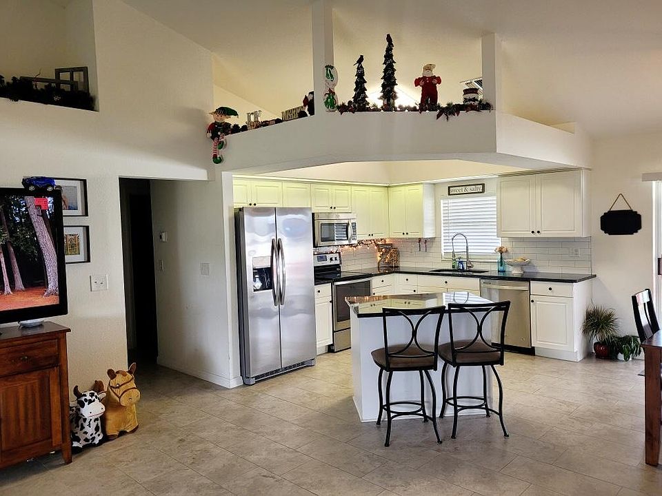 Open Kitchen, black granite, stainless appliances, subway tile backsplash