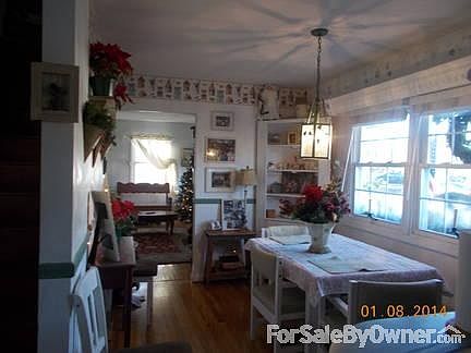 Dining room
						:
						Two double-hung windows with large slat wooden blinds. Real hardwood floors