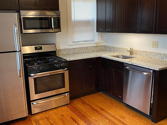 Beautiful updated kitchen with stainless steel dishwasher, garbage disposal, gas range, microwave and refrigerator. Gorgeous granite countertops!