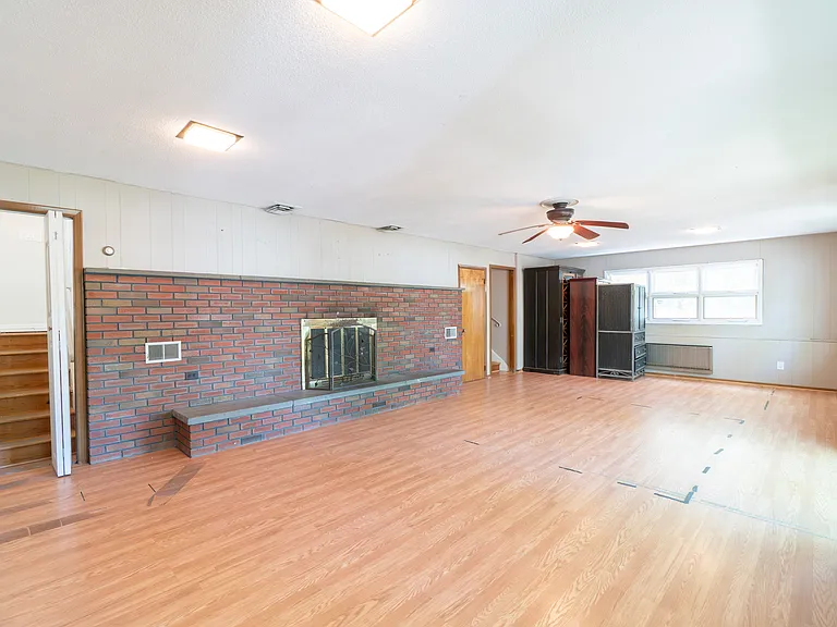 30 x 18 huge family room has working fireplace, a dozen windows and double sliding glass doors to patio