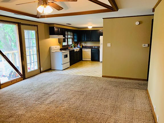 Living area looking at kitchen. To the right is the bedroom and bathroom. To the left is the doorway to the balcony.