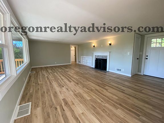 Main Living Area with Fireplace looking into hall with 3 bedrooms and 1 bathroom