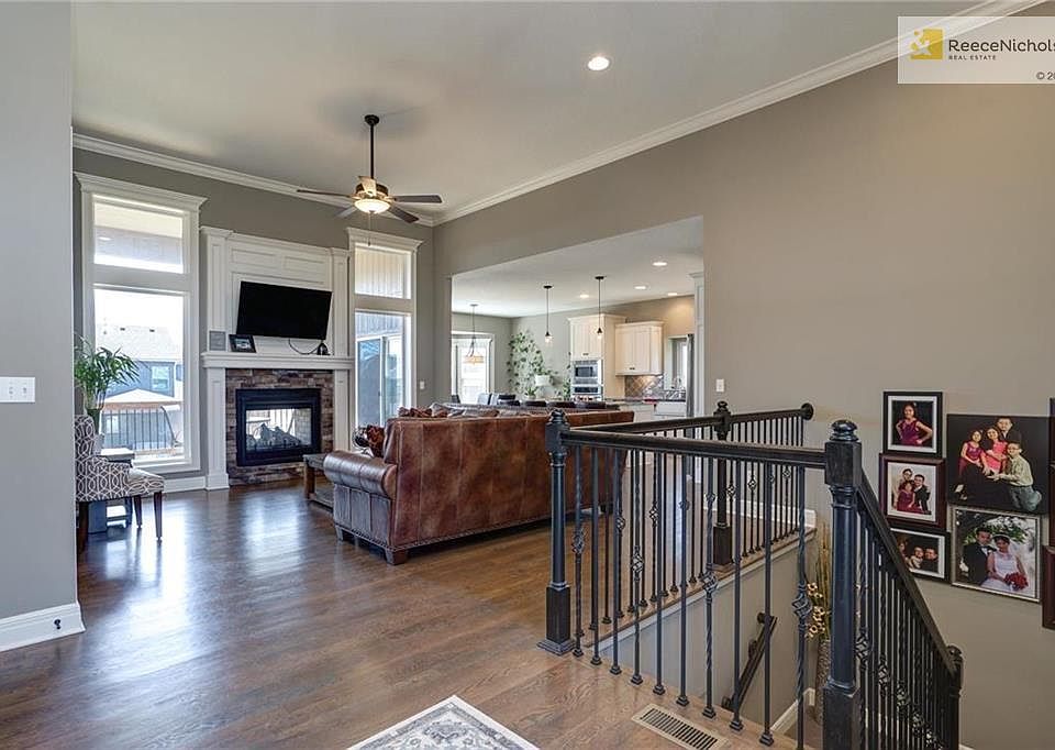 Main level boasts open floor plan, inviting Family Room with towering ceilings and the Hearth as the focal point flanked on each side by floor-to-ceiling windows.