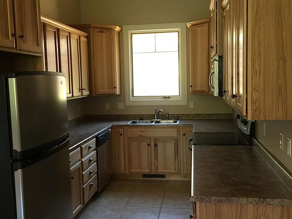 Kitchen with lots of cabinetry and stainless steel appliances - stove, microwave, dishwasher and refrigerator/freezer