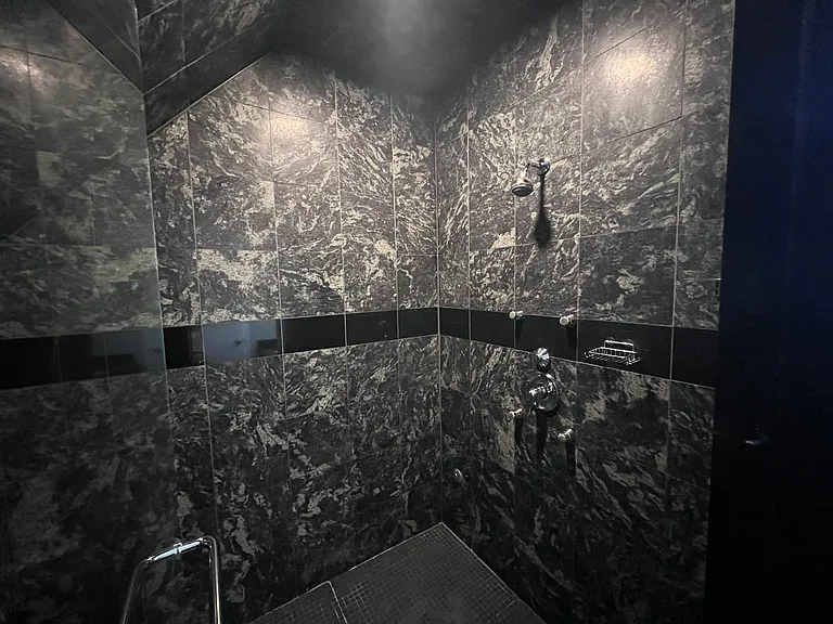 Large shower with bench in the second floor bedroom
