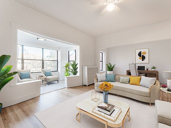 Living room opens up to sunroom and den