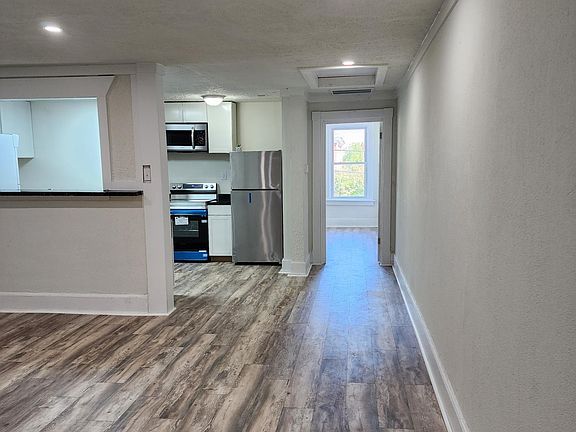 Hallway looking into kitchen and master bedroom.
