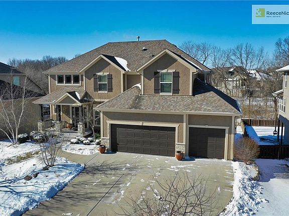 This well-appointed home backs to greenspace with a creek and mature trees.