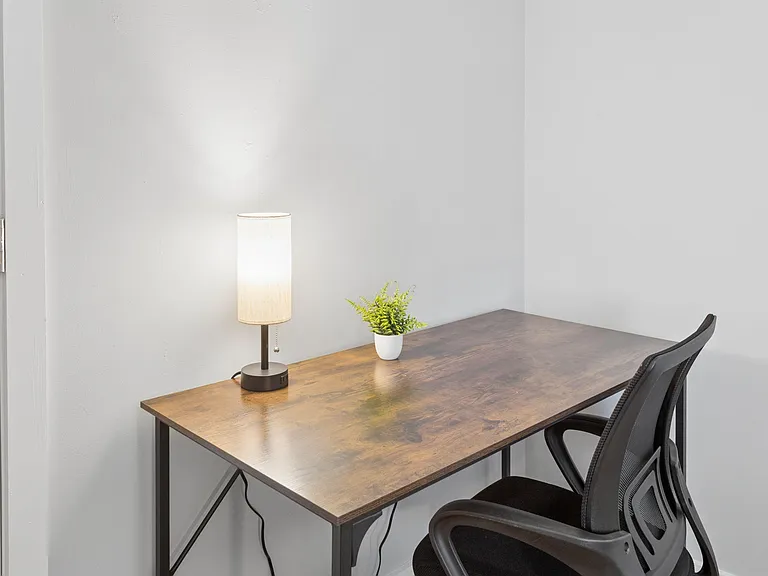 Dedicated workspace with a desk, task lamp, and chairideal for studying, remote work, or managing daily tasks.