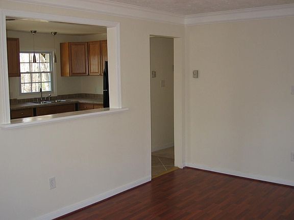 Living room showing new laminate wood floor, new pass-through