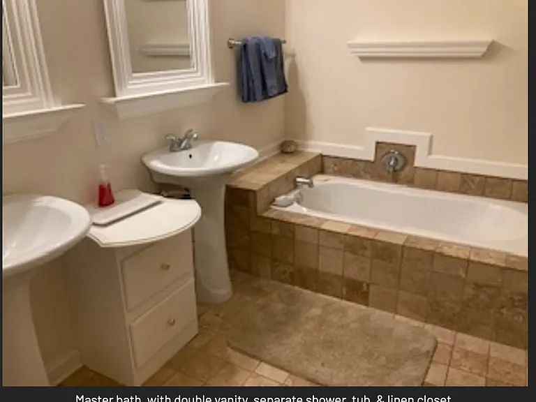Master bathroom adjoins master bed room, with double vanities, separate shower and tub & linen closet.