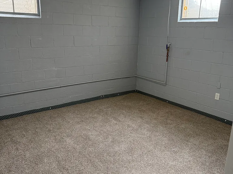 Living/office room next to the bedroom to make a large suite for the tenant in the lower level