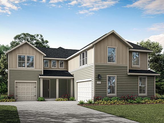 A two-story residential house with a garage, surrounded by lush greenery and a clear blue sky with s