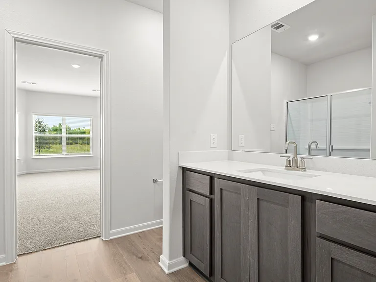 The master bathroom has a sprawling vanity.