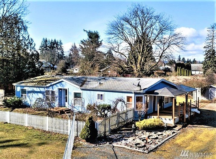 Front & side view of the home as you come down driveway. Note rock garden in front meticulously prepared for your enjoyment! Dual Gazebo's on side deck add additional living space!
