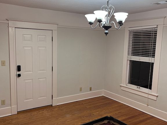 Living room facing front door with electronic locks.