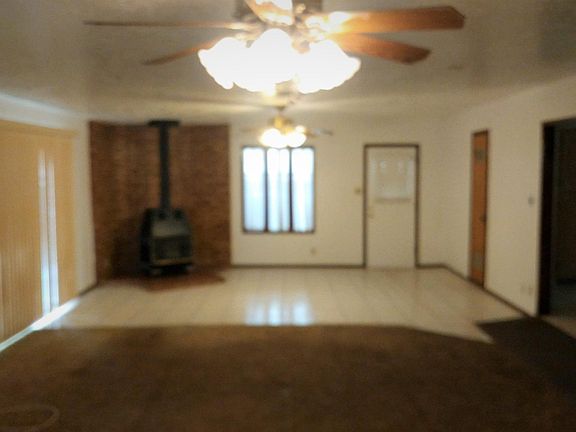 Wood stove warms great room and kitchen. Access to backyard through side door or rear sliding door. In addition, sliding window/door provides nice views to backyard.