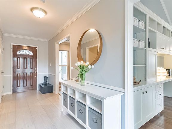 ENTRY WITH WOOD LOOKING TILE FLOORING AND CROWN MOLDING