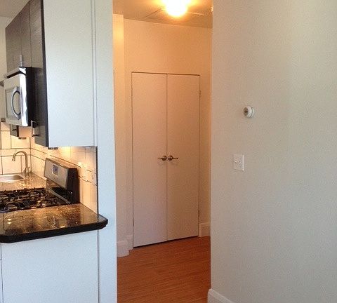 Hallway with more closet space....leading to full bathroom a