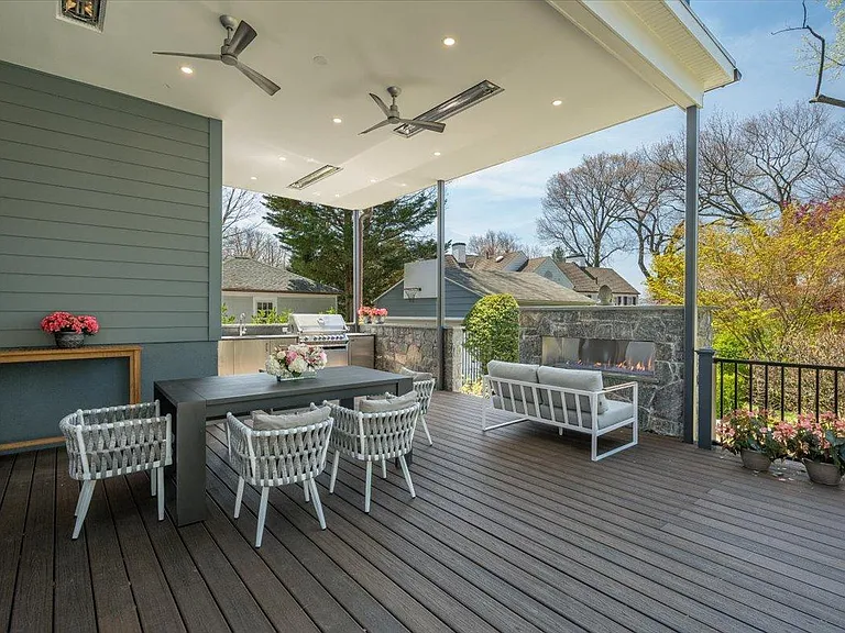 Covered 950+ sq ft patio, with built-in ceiling heaters, fans, recessed lights, custom kitchen, and gas fireplace.