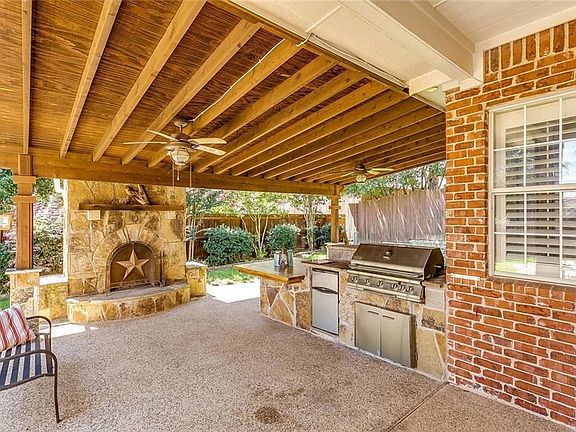 Entertain on the covered patio complete with a built-in bar & grill, plus a stone fireplace.
