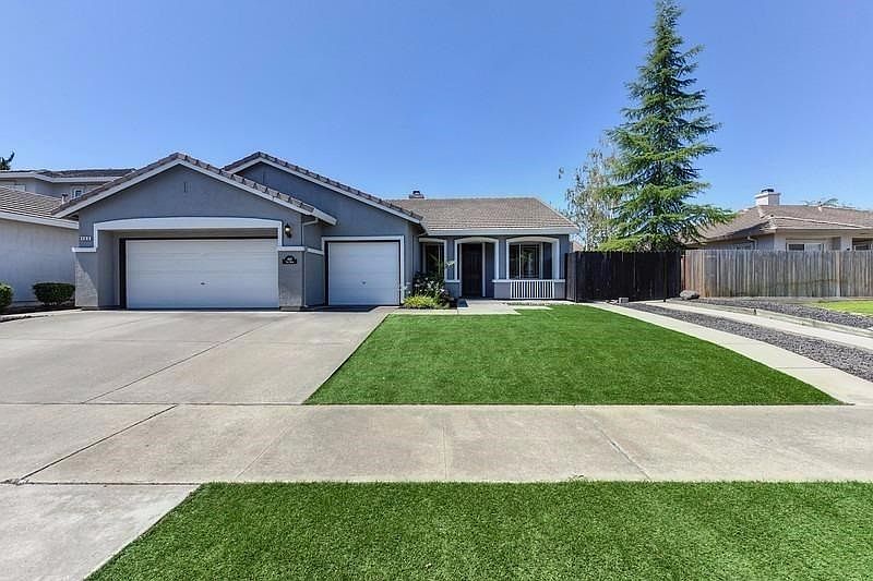 This lovely home's exterior has been freshly painted and features low maintenance landscaping in the front and backyards.