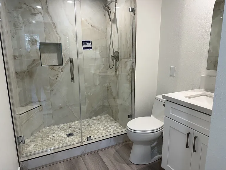 Luxury bathroom with Kohler fixtures and an 8mm frameless glass shower.