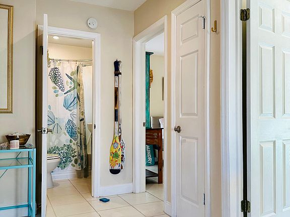Entryway view of 2 bedroom and bathroom doors