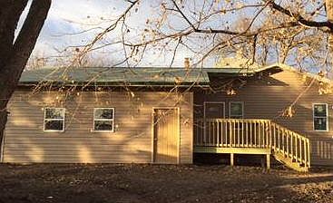 Back of house with deck