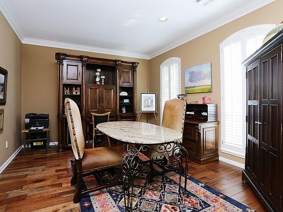 Study features hardwood floors & plantation shutters
