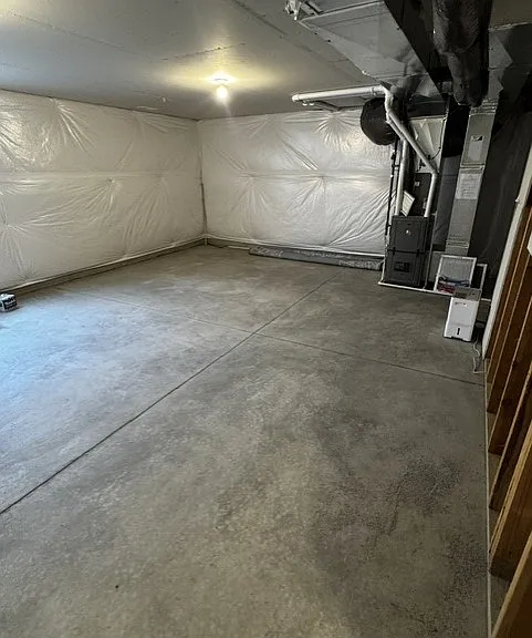 Unfinished basement with egress window for natural light