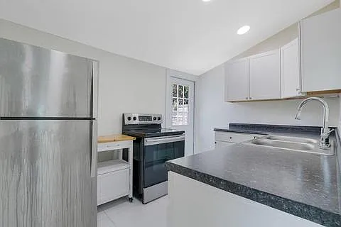 Kitchen: electric stove, full size fridge stainless steel. No dishwasher.
Door out to side, rear yard