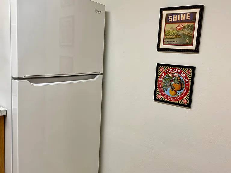 Refrigerator and framed "Old Florida Orange Crate Labels"
