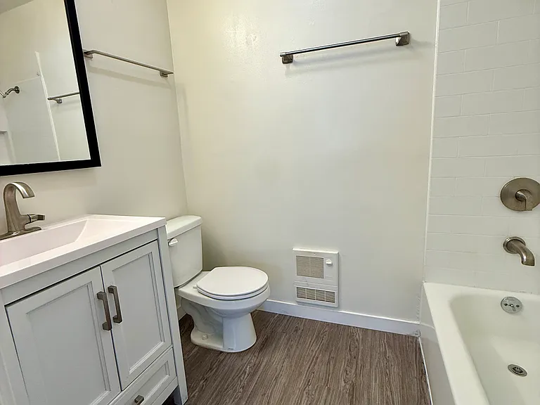 Bathroom with vanity, toilet, bathtub and medicine cabinet.