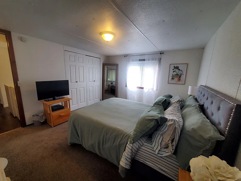 Another view of larger bedroom.