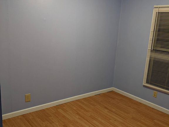 Bedroom at end of unit. Room size is 8' x 11.5'. Color is light purple.