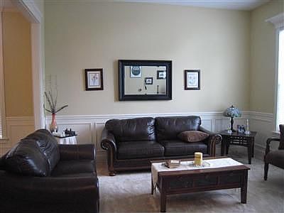 Sunny formal living room also with chair rail and