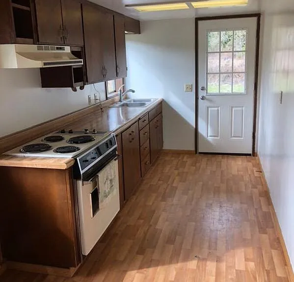 Kitchen with door to driveway & large side yard.