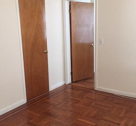 Living room with bedroom and closet entrances