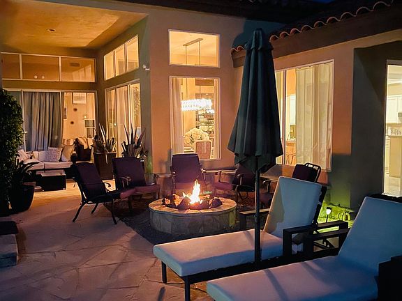 Fire pit lounge area with view of covered lounge area
