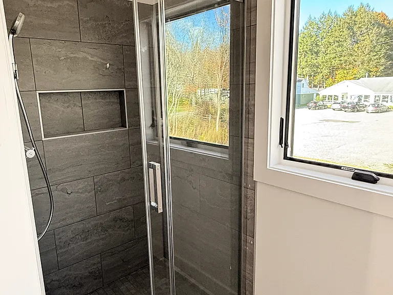 Shower with glass sliding doors featuring European Grohe fixtures