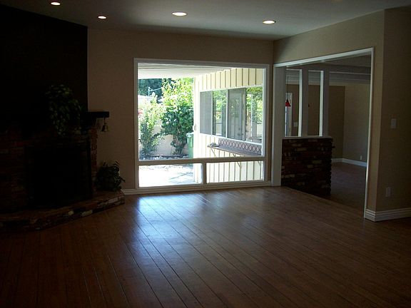 Living room with view of backyard and pool