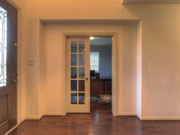 Study has french doors and crown molding!