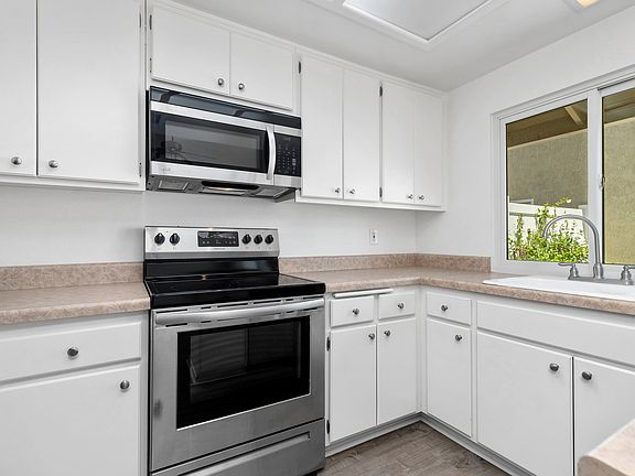 Stainless appliances and tons of storage in kitchen.