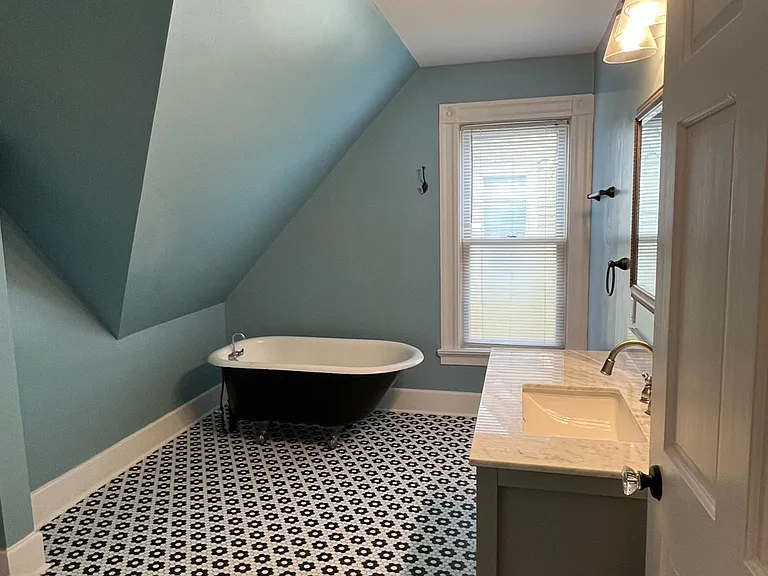 Large bathroom with bathtub and large shower stall.