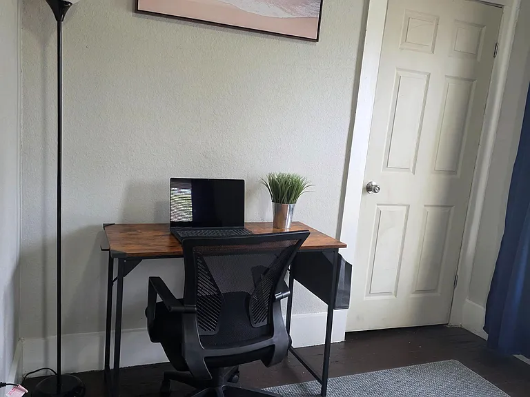 Dedicated work nook with a desk, task lighting, and an ergonomic chairideal for remote work or studying.