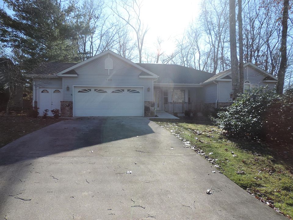 Front of house with covered porch, oversized 2 car garage with side door.