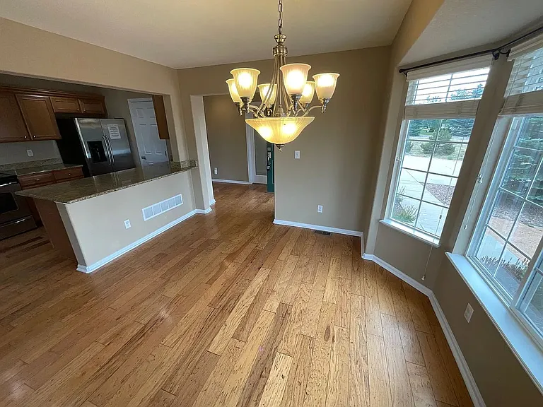 Beautiful dining space with natural bay windows and hardwood floors!