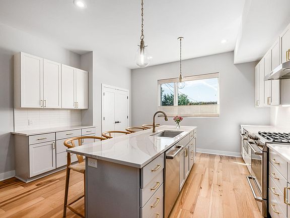 walk upstairs to the gourmet kitchen, featuring 10' ceilings, custom quiet-close cabinetry, and large pantry closet.