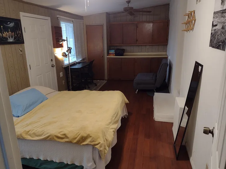 Master bedroom bed, desk and overall view of the bedroom